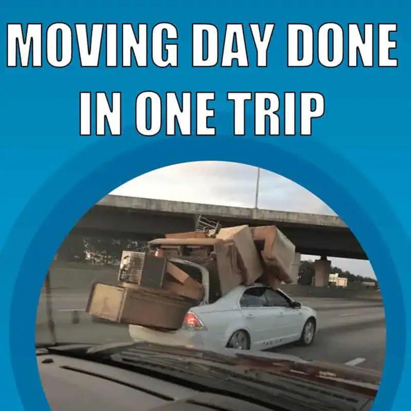 Car overloaded with furniture during moving day, driving under a bridge.