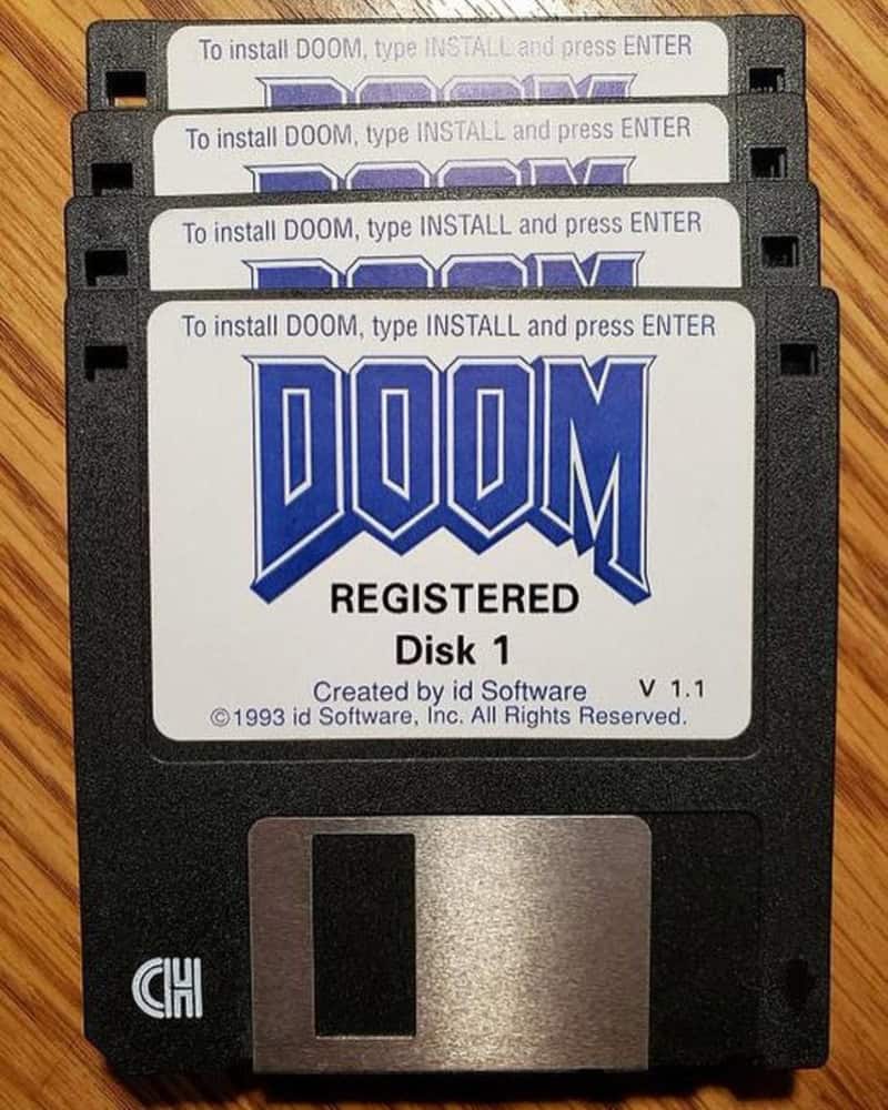 Floppy disk labeled "DOOM" with "REGISTERED" and software details.
