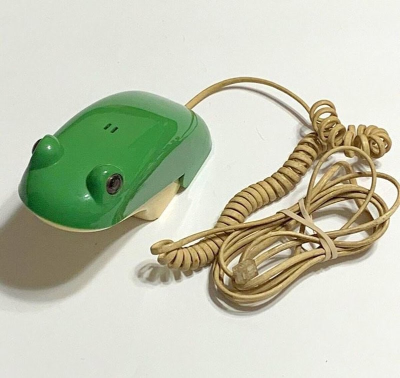 Cute green animal-themed computer mouse with a beige coiled cord, designed for comfortable use.