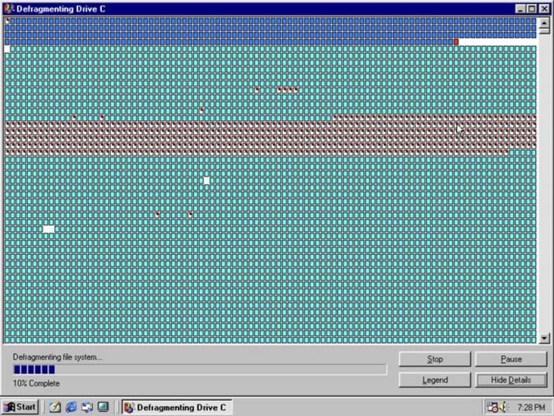 Computer screen showing defragmentation process on Drive C with colorful pixels.