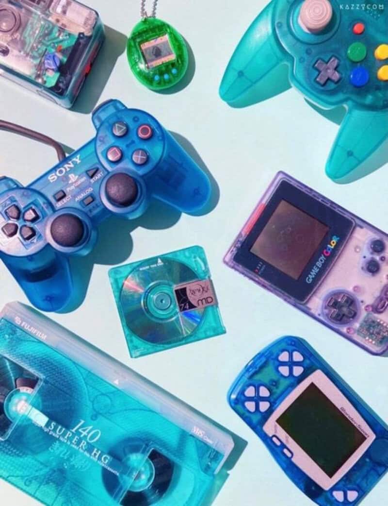 Retro gaming consoles and accessories with colorful controllers and handheld devices.