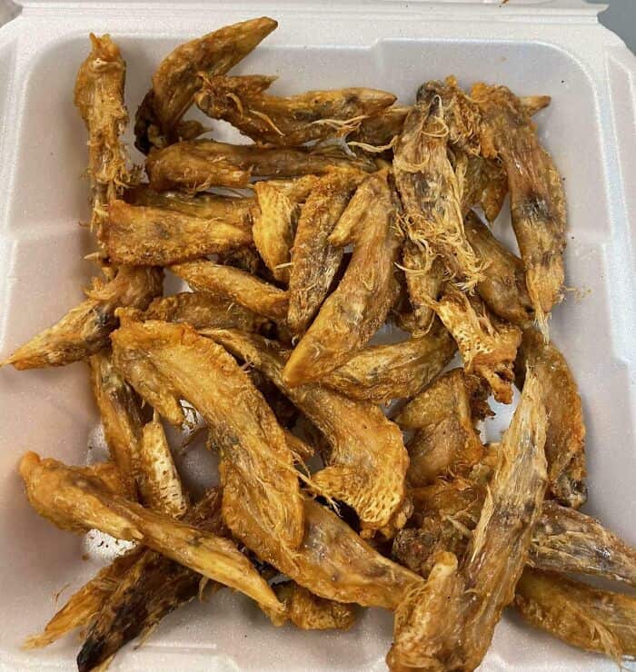 Crispy fried chicken wings on a foam tray, perfect for snacks or meals.