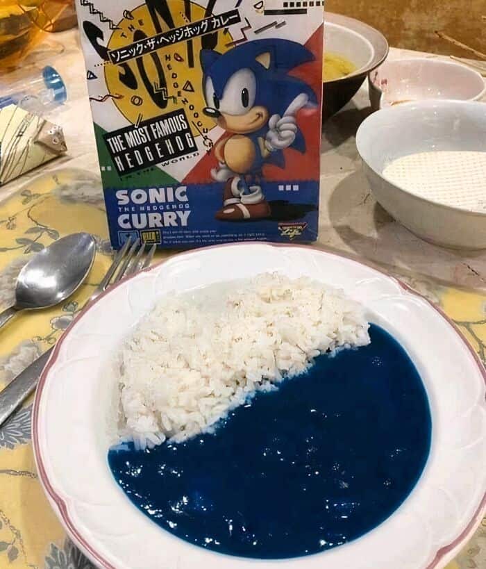 Sonic-themed curry dish with blue rice and curry box on a table.
