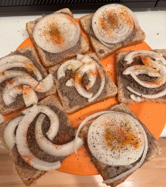 Eggs and onions on toast, resembling a humorous cursed food meme, with a focus on breakfast and food.