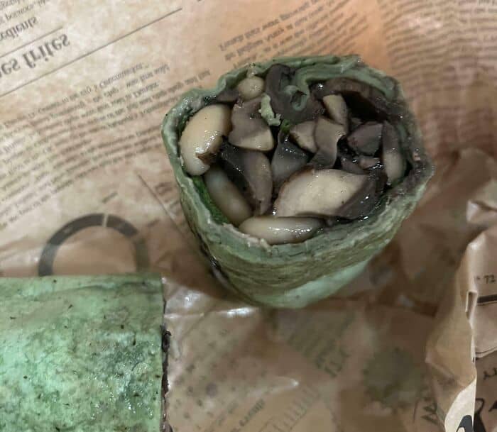 Moldy green roll with mushrooms and vegetables, part of cursed food collection.
