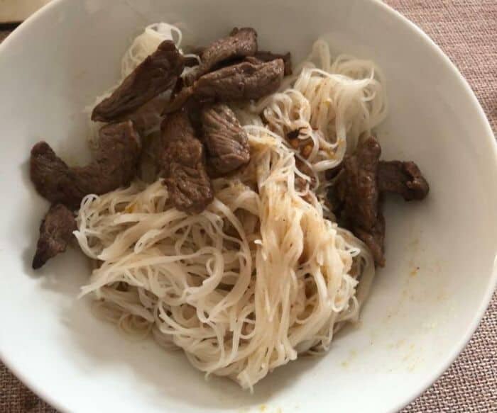 Unappetizing beef and noodle dish with questionable presentation.