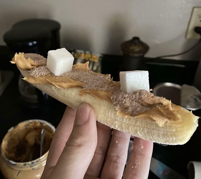 Banana with peanut butter, sugar cubes, and unusual topping.