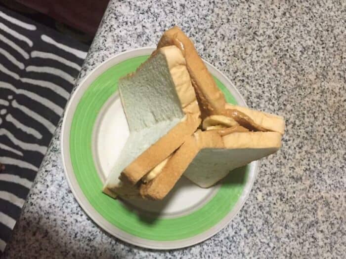 Unappetizing sandwiches with strange filling on a green plate.