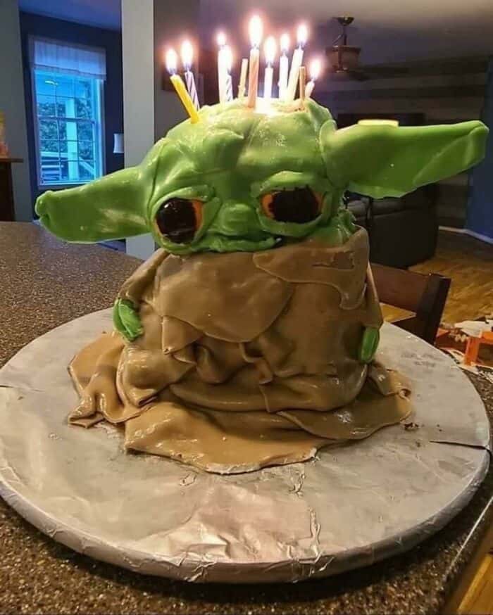 Baby Yoda cake with candles, inspired by cursed food theme.