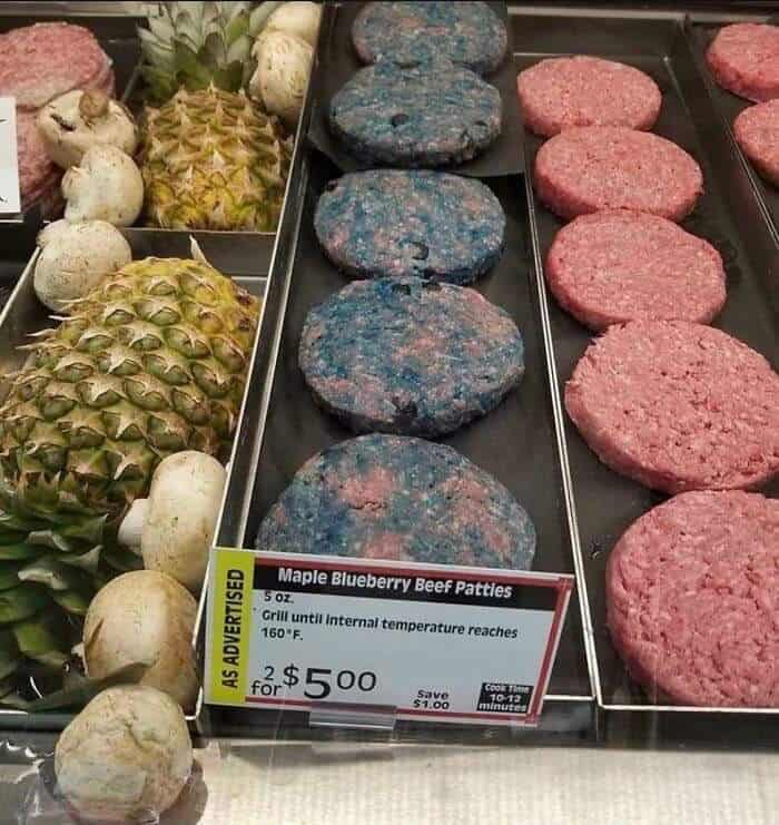 Unusual blue-colored beef patties with blueberry flavor, displayed in a grocery store.