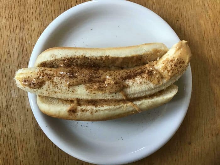 Overripe banana with cinnamon on a white plate, cursed food theme.