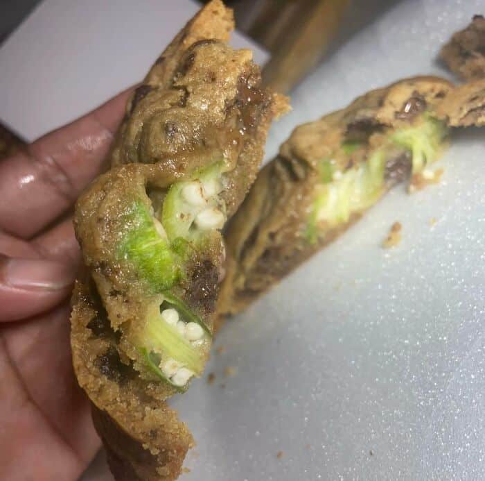 Fried jalapeño pepper with a strange, unappetizing filling, showcasing a bizarre food creation.