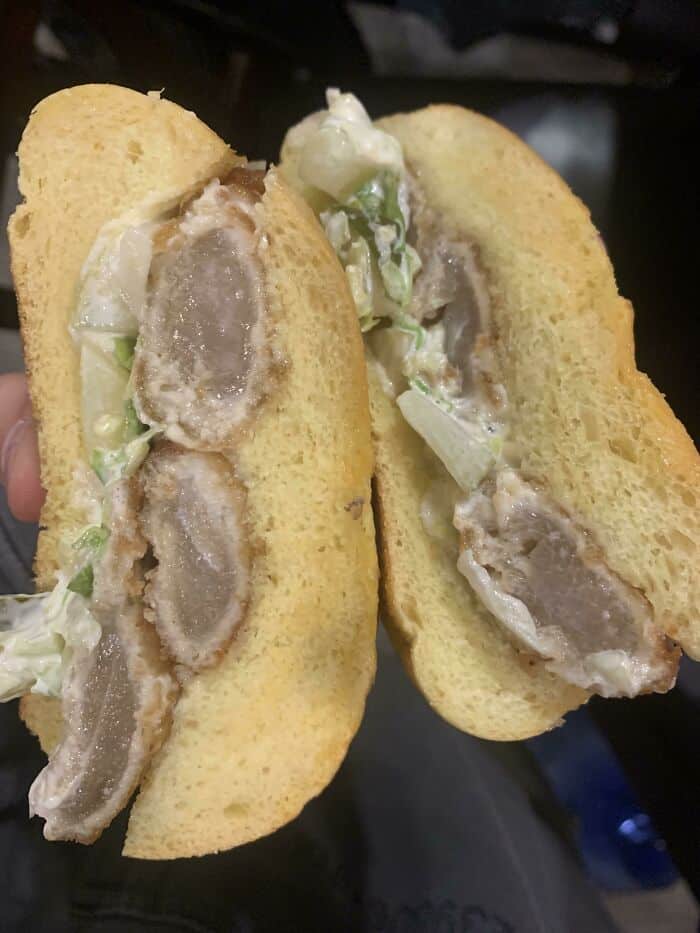 Fried chicken sandwich with a strange, unappetizing filling inside, part of the cursed food collecti.