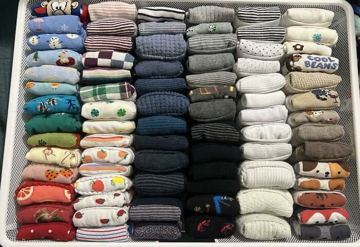 Neatly arranged colorful socks in a drawer for easy access and organization.