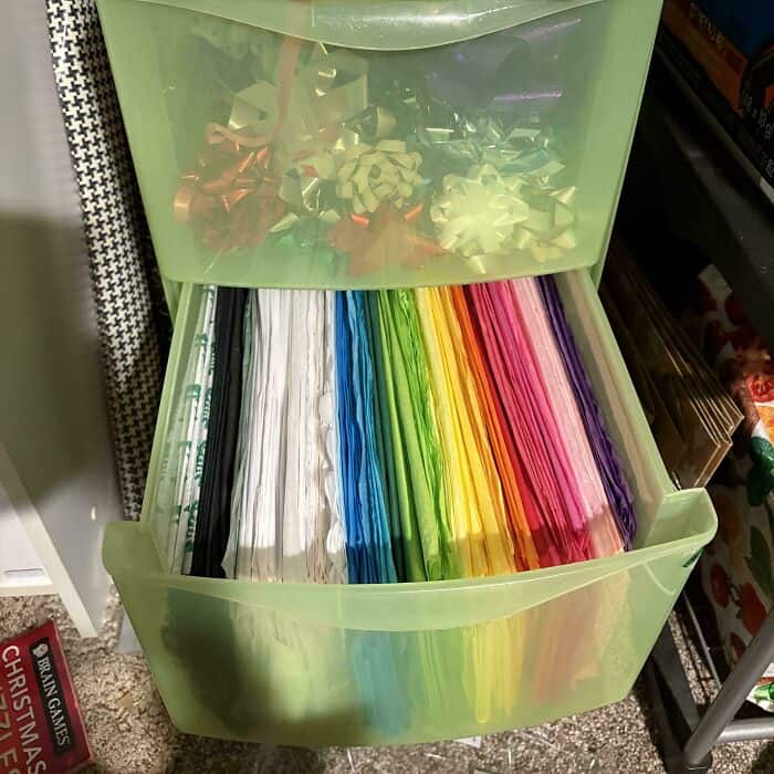 Colorful paper strips organized in a plastic drawer for crafts.