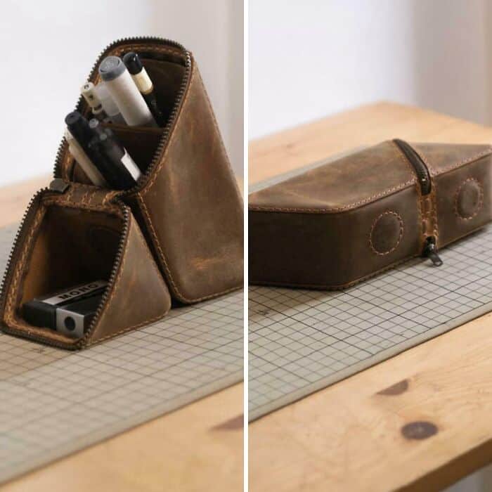 Organized leather pencil case with compartments for pens, markers, and accessories.