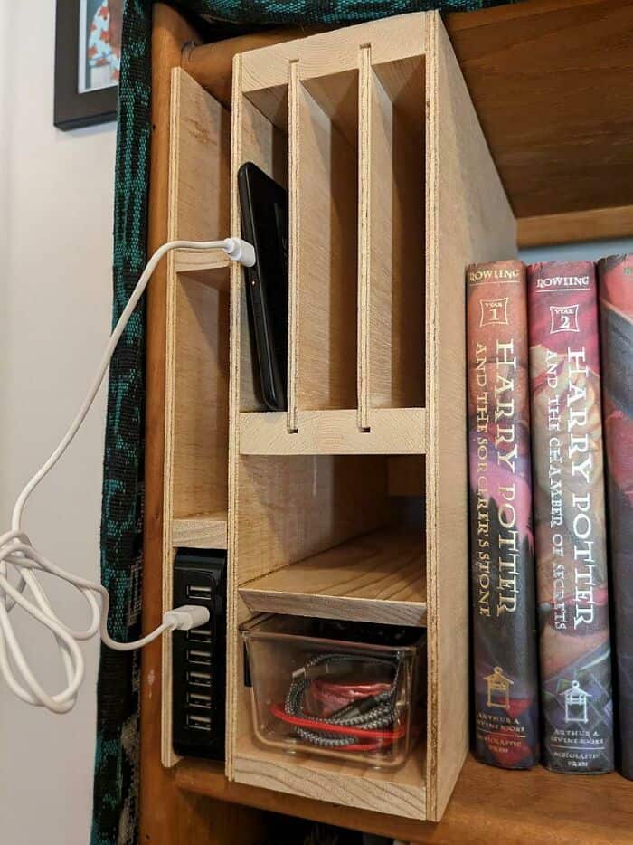 Wooden desk organizer with compartments for gadgets and accessories.