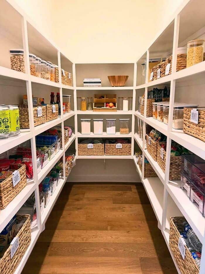 Organized pantry with neatly arranged jars and baskets for easy access.