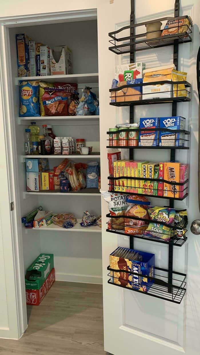 Pantry with neatly arranged snacks and food items on shelves and wall racks.