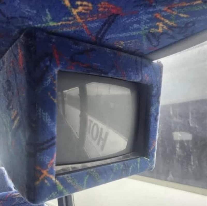 Old television with a fabric-covered frame and a small screen.