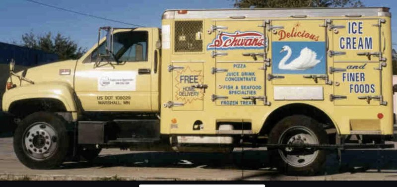Yellow ice cream truck with swan logo and menu items in Marshall, MN.