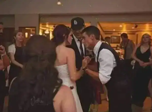 Wedding reception dance with guests and bride in a hotel lobby.