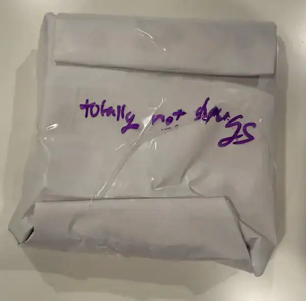 Crumpled paper with handwritten note "today not doing" in purple ink.