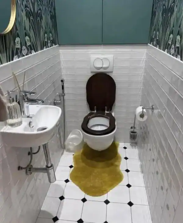 Unique bathroom with a small sink and a toilet with a dark brown seat and lid.