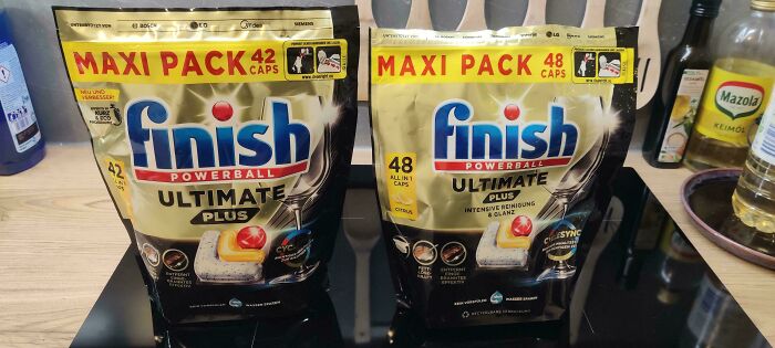 Finish Powerball Ultimate Plus dishwasher detergent capsules, large packs on a store shelf.