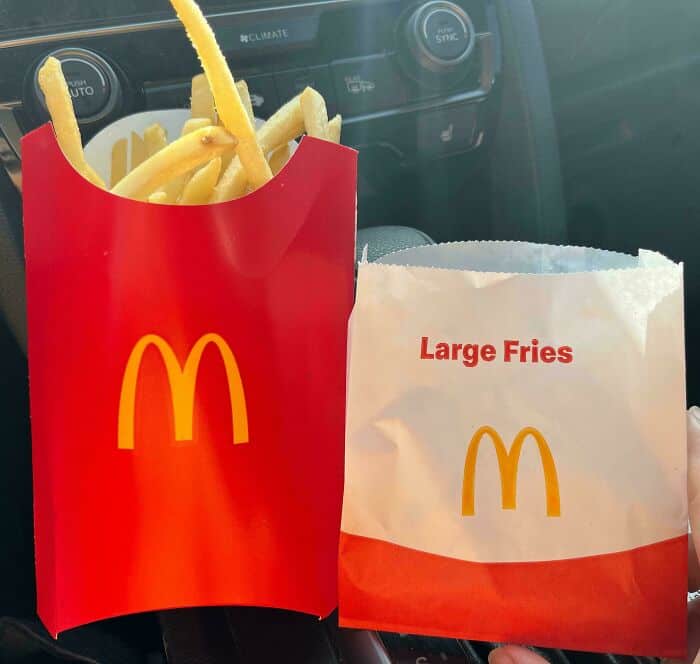 McDonald's large fries in red and white packaging with the golden arches logo.