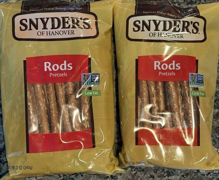 Snyder's of Hanover Rods Pretzels, two yellow bags with transparent window showing pretzels inside.