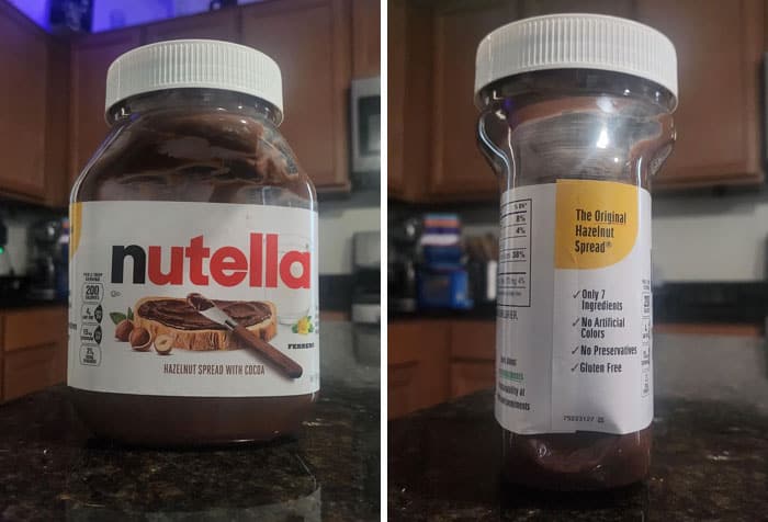 Nutella jar with label showing hazelnut spread with cocoa, on a kitchen countertop.