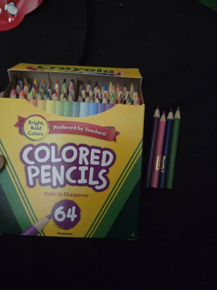 Bright colored pencils in a box with some outside, labeled "Colored Pencils" with "Preferred by Teac.