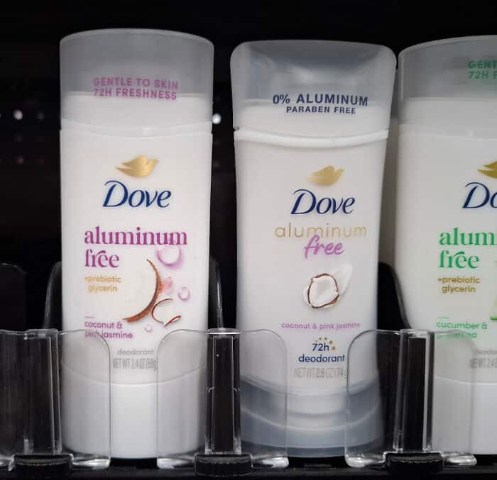 Dove aluminum free deodorant bottles on store shelf, with different scents and labels.