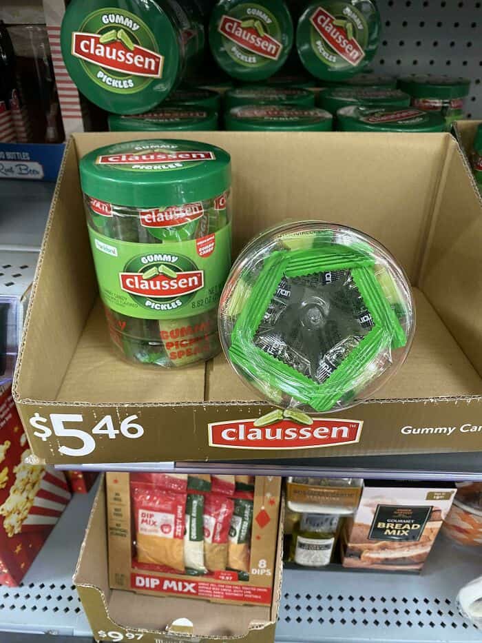 Gummy Claussen pickles in a display box with a container and a pack of dip mix.