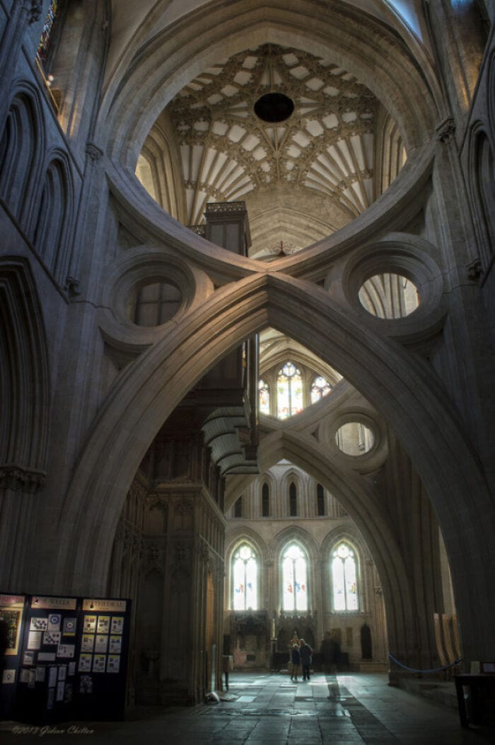 The intricate architecture of a Gothic cathedral interior with soaring arches and stained glass wind.