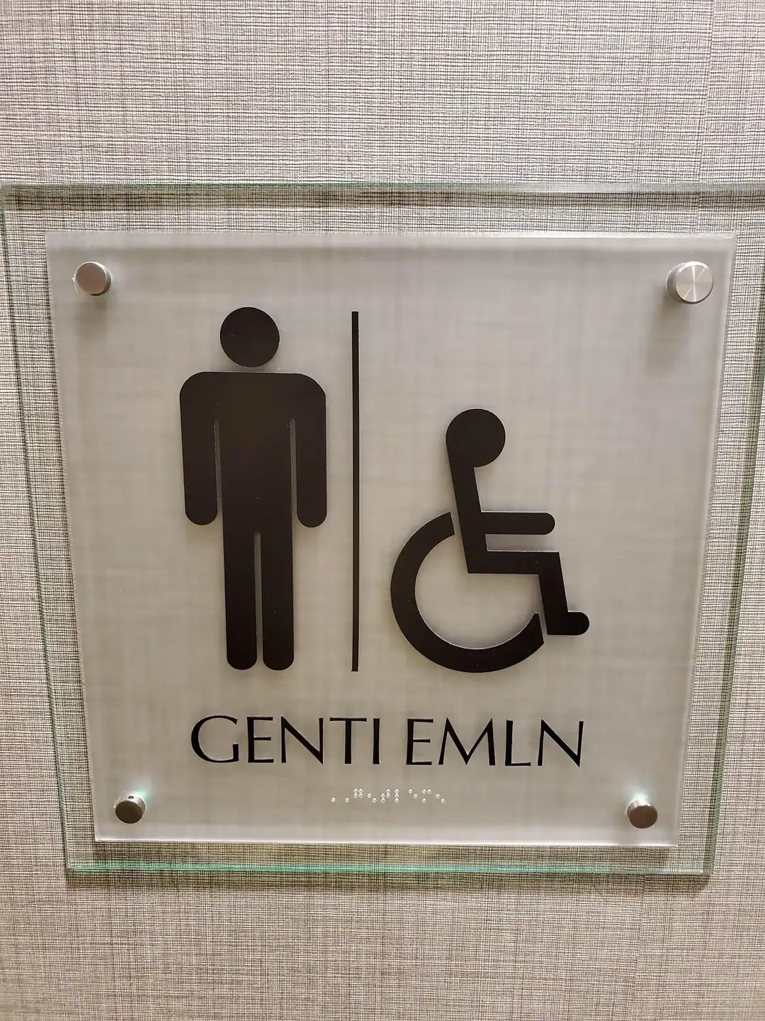 Accessible restroom sign with male and wheelchair symbols.