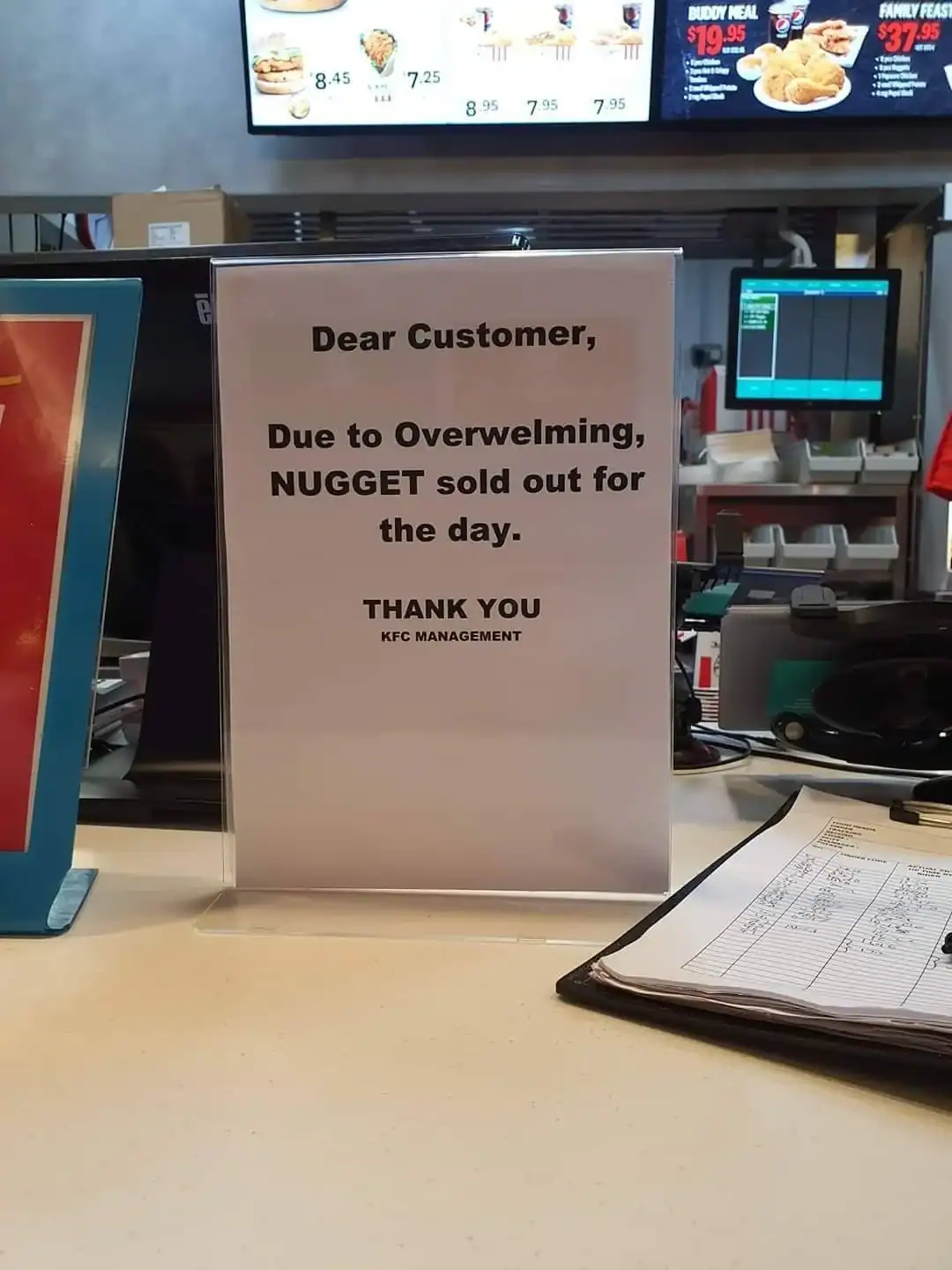 Out of stock sign at fast food restaurant due to high demand, informing customers about unavailabili.