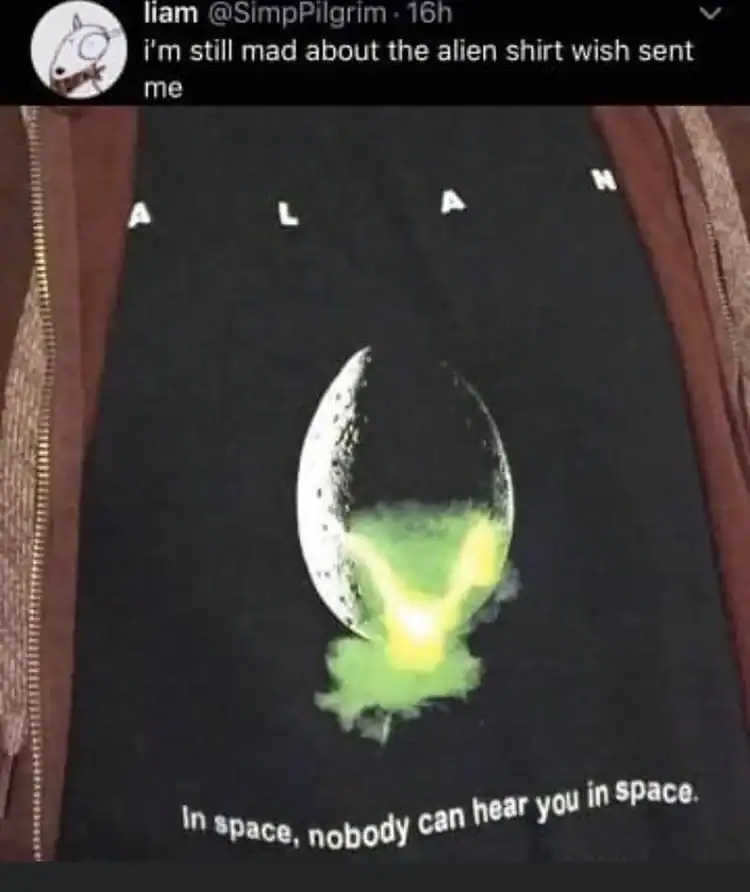 Black T-shirt with a moon and green alien graphic, humorous space-themed design.