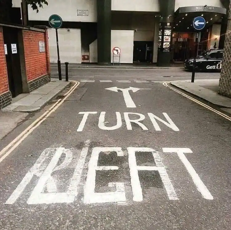 Turn right on the road with a painted arrow and the word "TURN".