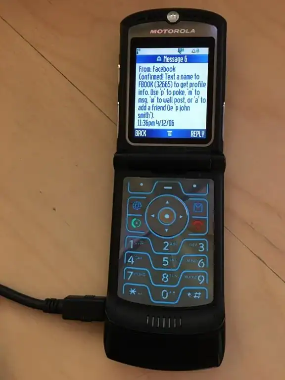 Mobile phone displaying a text message on a Motorola flip phone.
