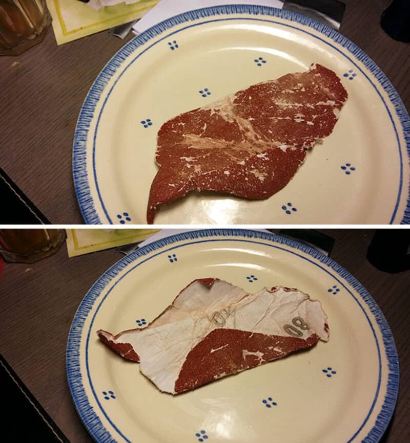 Raw steak on a decorative plate with paper towel underneath.