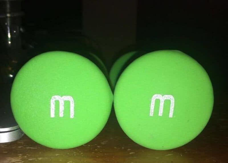 Tennis balls with "m" logo, bright green color, close-up shot.