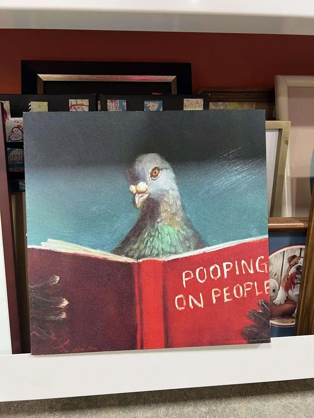 Humorous painting of a pigeon reading a book with a "Pooping on People" sign.