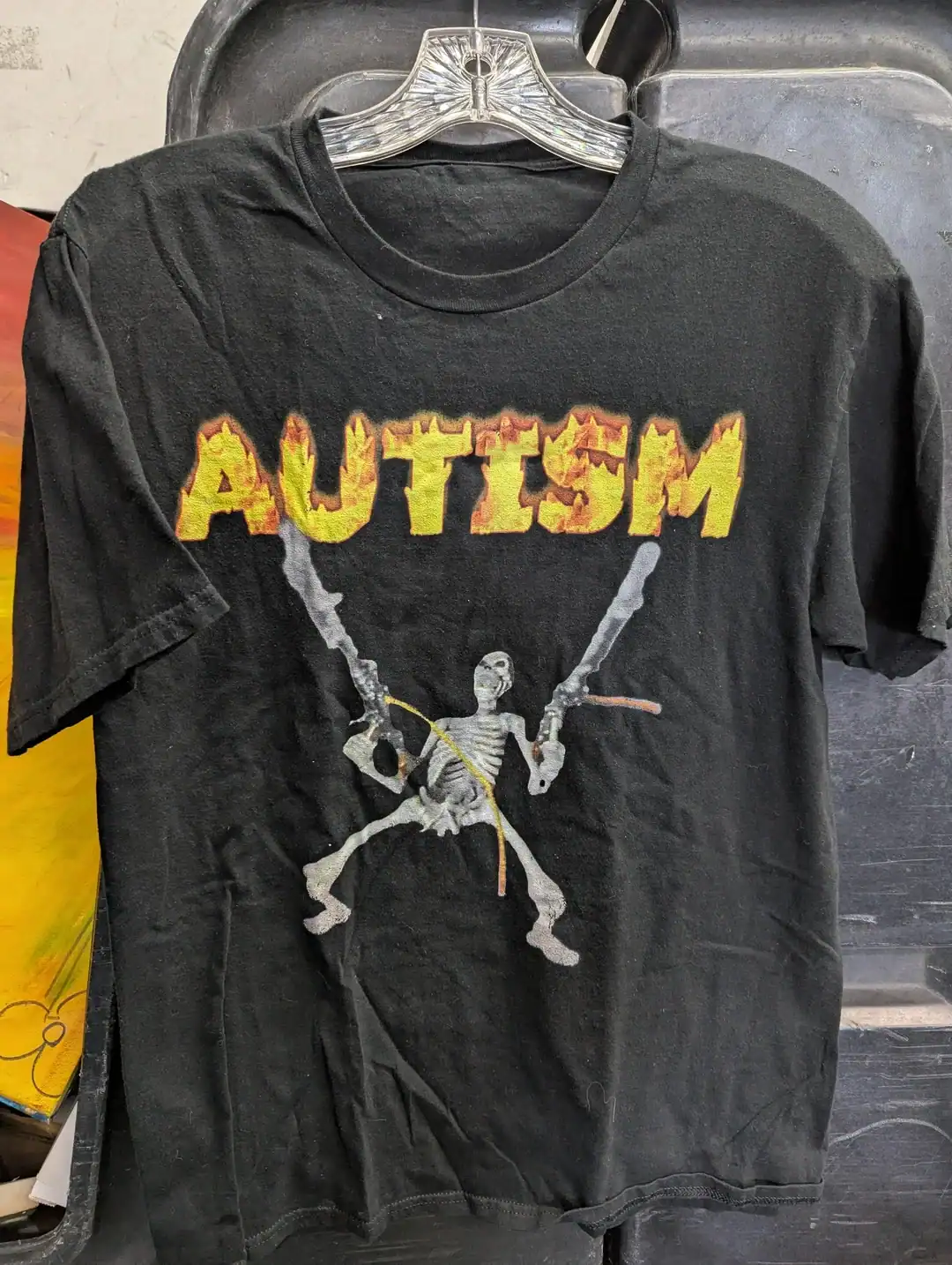 Black T-shirt with skeleton holding autumn leaves and "AUTUMN" text.