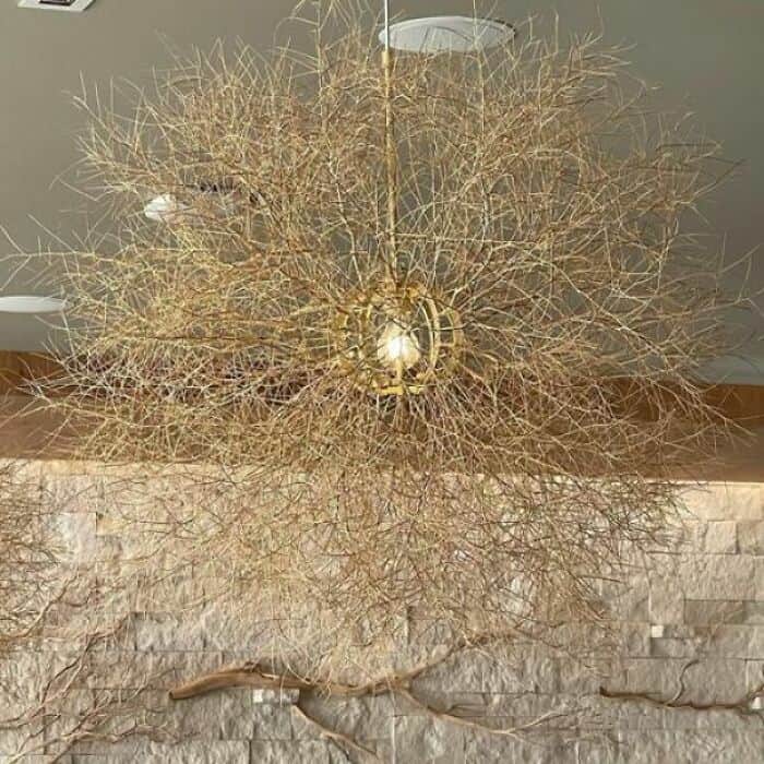 Gold wire chandelier with intricate design and warm lighting.