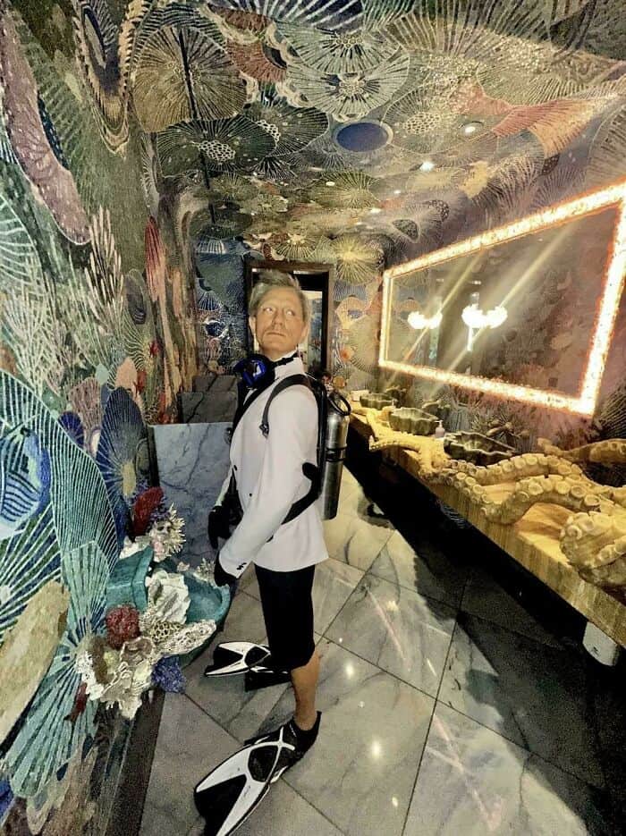 Person exploring an art-filled, colorful museum exhibit.