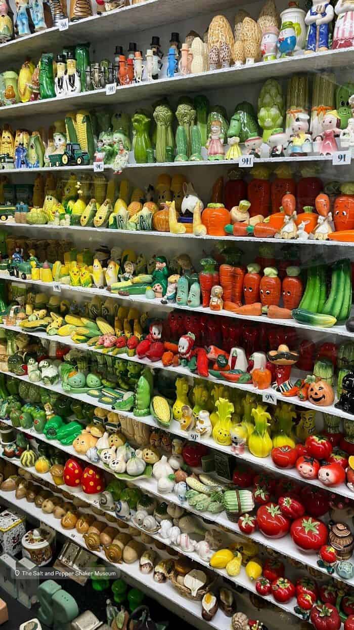 Colorful collection of vintage toy vegetables and fruits on store shelves.