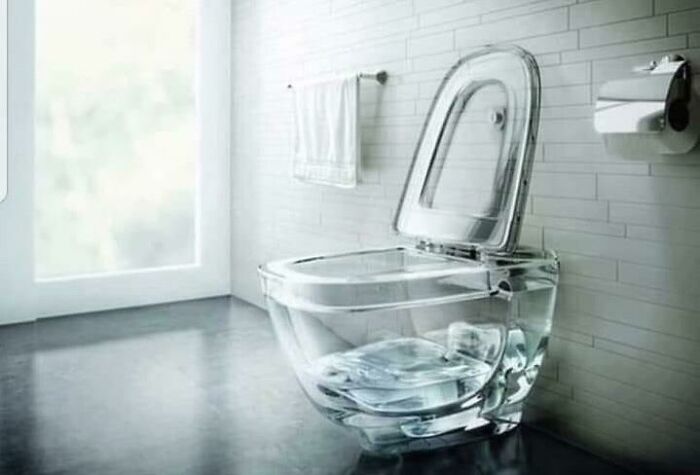 Unique transparent glass toilet with sleek design in contemporary bathroom setting.