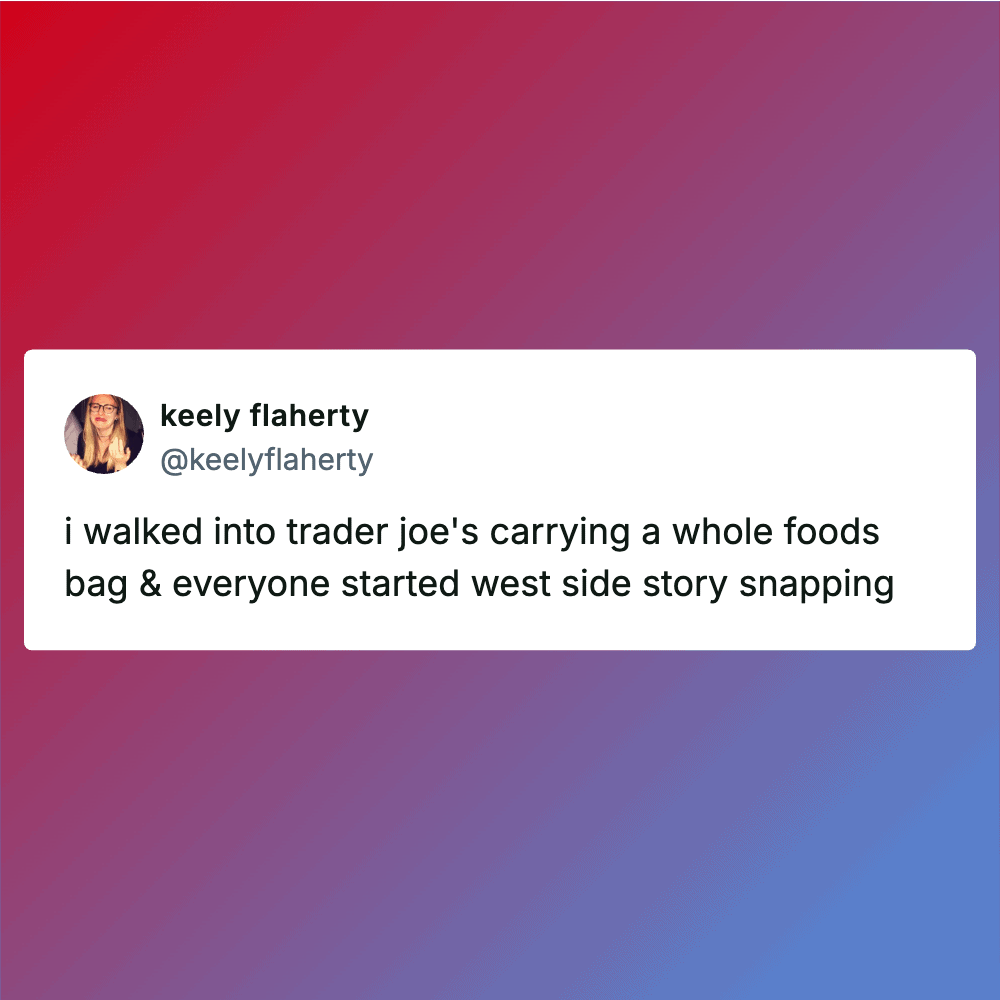 Person carrying a large grocery bag at Trader Joe's store.